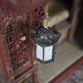 Load image into Gallery viewer, Decorative lantern hanging from a traditional wooden structure