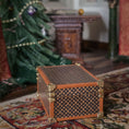 Load image into Gallery viewer, Decorative chest on a patterned rug with a Christmas tree in the background