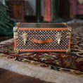 Load image into Gallery viewer, Vintage-style suitcase or chest with patterned design on a textured surface