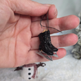 Load image into Gallery viewer, Hand holding a Dollhouse miniature pair of figure skates with a blurred background