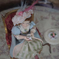 Load image into Gallery viewer, Seated Porcelain Little Girl Doll with Teacup, Pink Feathered Hat & Leather Shoes