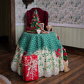 Load image into Gallery viewer, Decorative table setting with a Christmas tree and gift box in a room with floral wallpaper.