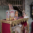Load image into Gallery viewer, Decorative miniature scene with a gold frame, red fabric, and vintage-style elements.