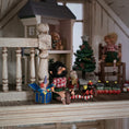 Load image into Gallery viewer, black-bearded elf dollhouse doll surrounded by toys