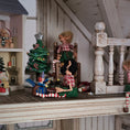 Load image into Gallery viewer, Miniature Christmas scene with elf dolls and decorations on a wooden surface.