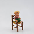 Load image into Gallery viewer, Christmas elf with glasses by artist Cynthia Baron, in chair on white background