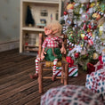 Load image into Gallery viewer, Christmas elf with glasses by artist Cynthia Baron, in chair