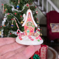 Load image into Gallery viewer, Candy cane gingerbread house in hand
