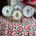 Load image into Gallery viewer, Decorative plates with Christmas-themed designs on a floral tablecloth.