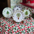 Load image into Gallery viewer, Set of decorative plates with Christmas-themed designs on a floral tablecloth.