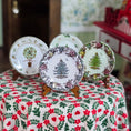 Load image into Gallery viewer, Set of decorative plates with Christmas tree designs on a floral tablecloth.