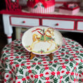 Load image into Gallery viewer, Decorative dollhouse plate with a rocking horse design on a tablecloth with floral pattern