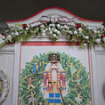 Load image into Gallery viewer, Decorative wall piece with a nutcracker design and Christmas garland above it.
