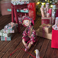 Load image into Gallery viewer, Hand-Sculpted Clay Elf Boy in Raspberry Pink in a festive setting with wrapped gifts and a Christmas tree.