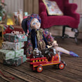 Load image into Gallery viewer, Vintage-style Sculpted clay elf boy doll wearing a purple outfit with a toy fire truck and wrapped gifts on a wooden surface.