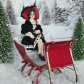 Load image into Gallery viewer, “Winter Lady” Doll in a black outfit with a red hat sitting on a red sleigh in a snowy landscape.