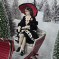 Load image into Gallery viewer, “Winter Lady” Doll in vintage attire sitting on a sleigh in a snowy landscape