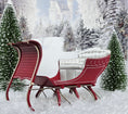 Load image into Gallery viewer, Red sleigh with white seat in a snowy landscape with trees and a castle.