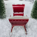 Load image into Gallery viewer, Red sleigh with white seats in a snowy landscape, top view