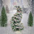 Load image into Gallery viewer, Decorated Christmas tree with green and gold ornaments against a snowy forest background