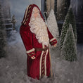 Load image into Gallery viewer, Santa Claus doll in a snowy scene with trees and a house.