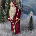 Load image into Gallery viewer, Santa Claus doll in a snowy landscape with trees and a dark sky.