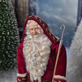 Load image into Gallery viewer, Santa Claus doll with a white beard and red robe in a snowy landscape.