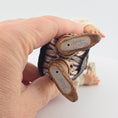 Load image into Gallery viewer, Hand holding the Sharon Cariola Elf dollhouse doll to show signature