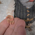 Load image into Gallery viewer, Close-up of the hand of Sharon Cariola's Elf dollhouse doll resting on a full size hand