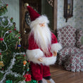 Load image into Gallery viewer, Santa Claus dollhouse doll next to a decorated Christmas tree in a festive room.
