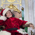 Load image into Gallery viewer, Santa dollhouse doll in a red costume with white fur trim sitting in an ornate chair.