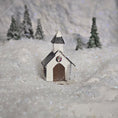 Load image into Gallery viewer, Small model of a church in a snowy landscape with trees in the background