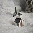 Load image into Gallery viewer, Small model of a church with a steeple on a snowy surface