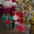 Load image into Gallery viewer, Decorative Christmas scene with wrapped gifts and a tree in a cozy room.