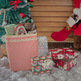 Load image into Gallery viewer, Christmas scene with wrapped gifts, a small tree, and a Santa Claus figure.