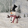 Load image into Gallery viewer, Decorative snowman miniature with a top hat and scarf against a snowy background