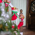 Load image into Gallery viewer, Decorative Christmas stockings with figurines on a staircase