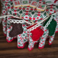 Load image into Gallery viewer, Decorative felt stockings on a floral fabric background