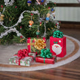 Load image into Gallery viewer, Miniature Christmas presents and ornaments on a wooden surface with a blurred Christmas tree in the background.
