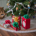 Load image into Gallery viewer, Small Christmas gift boxes with ribbons and Santa Claus design in front of a decorated tree.