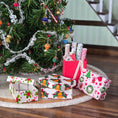 Load image into Gallery viewer, Christmas-themed Miniature dollhouse gift boxes and a tree with ornaments on a wooden surface.