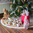 Load image into Gallery viewer, Small Christmas tree with Miniature dollhouse wrapped presents and a wooden horse figurine on a wooden floor.