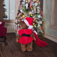 Load image into Gallery viewer, Back view of a Dollhouse Teddy bear in a red coat and Santa hat in front of a decorated Christmas tree.