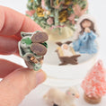 Load image into Gallery viewer, Hand holding a miniature dollhouse doll with initials 'CB'
