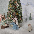 Load image into Gallery viewer, miniature dollhouse Nativity scene with figures and a decorated Christmas tree in a snowy setting