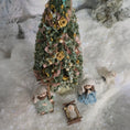 Load image into Gallery viewer, miniature dollhouse Christmas tree with ornaments and small figures on a snowy background