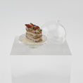 Load image into Gallery viewer, Shay Aaron Layered pastry with fruit on a small stand against a white background