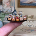 Load image into Gallery viewer, miniature pastries on platter, balanced on a finger