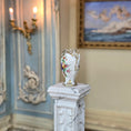 Load image into Gallery viewer, Decorative vase on a pedestal in an elegant room with wall art and candle holders.