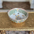 Load image into Gallery viewer, Decorative bowl with floral patterns on a gold surface